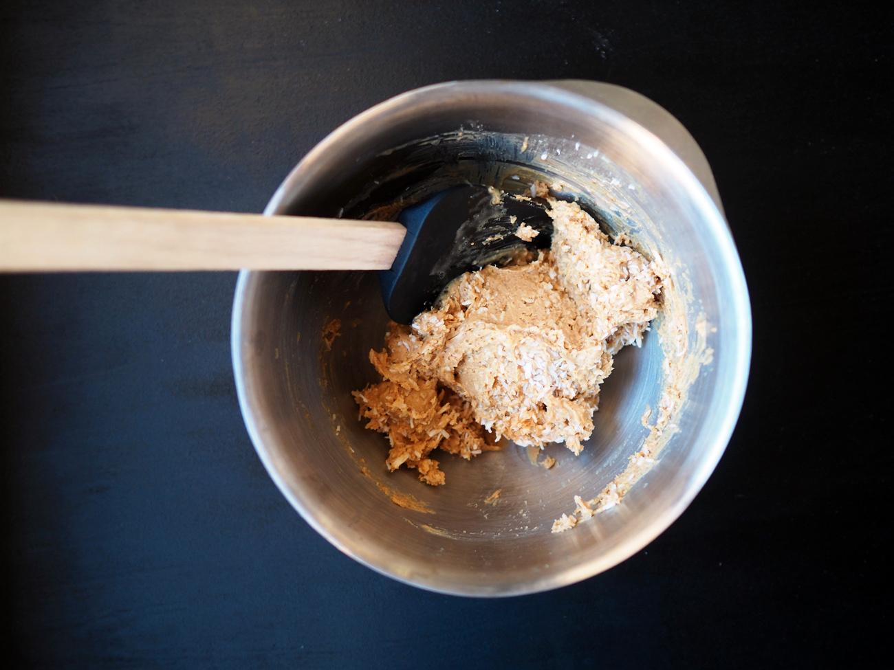 Tilsett vaniljepulver, kanel og salt og bland godt. Rør så inn 2 dl kokos, eller til massen er fast og formbar. Spar 1/2 dl til å rulle kulene i.
