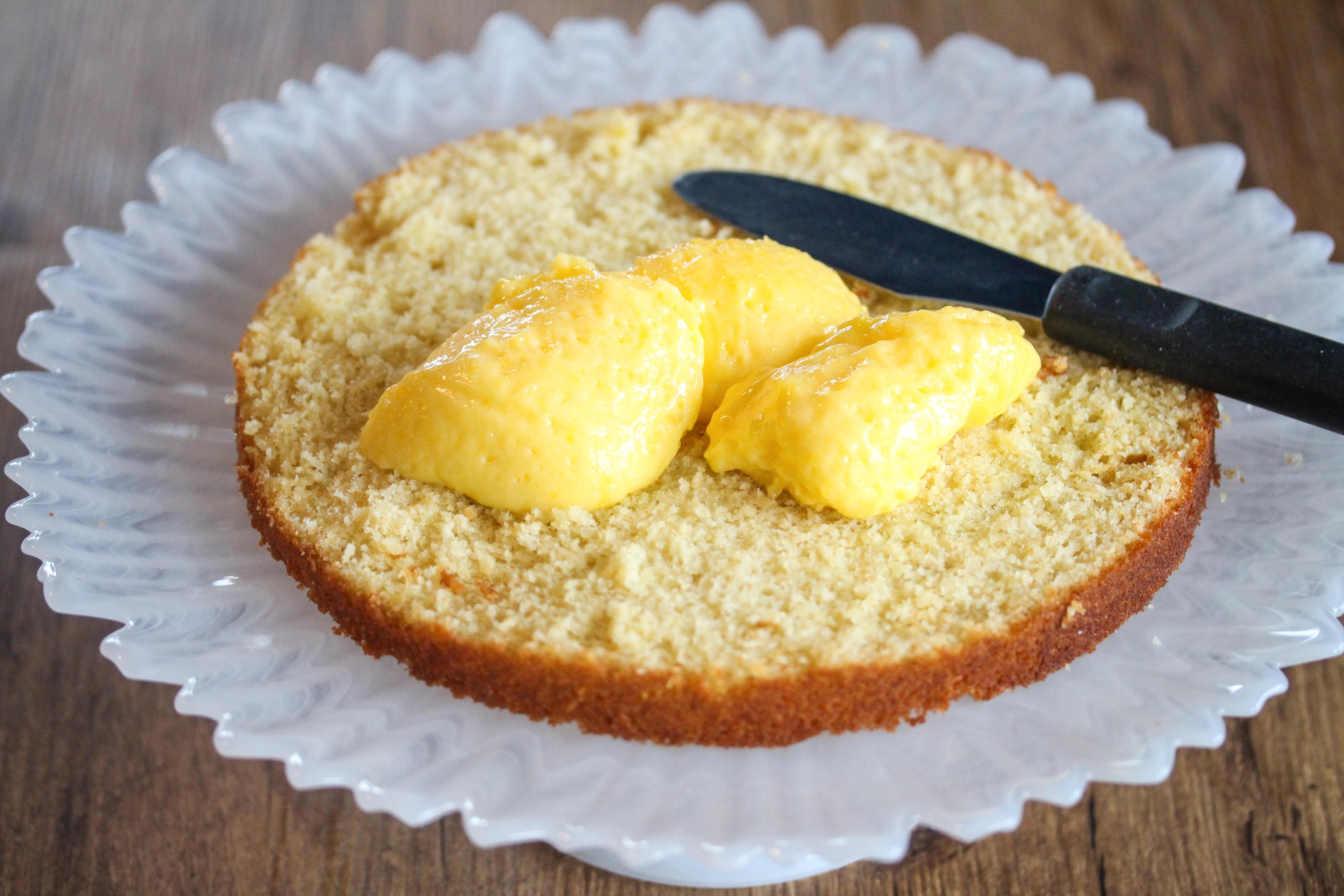 Del den kalde kakebunnen i to deler. Fyll kaken med sitronkremen.