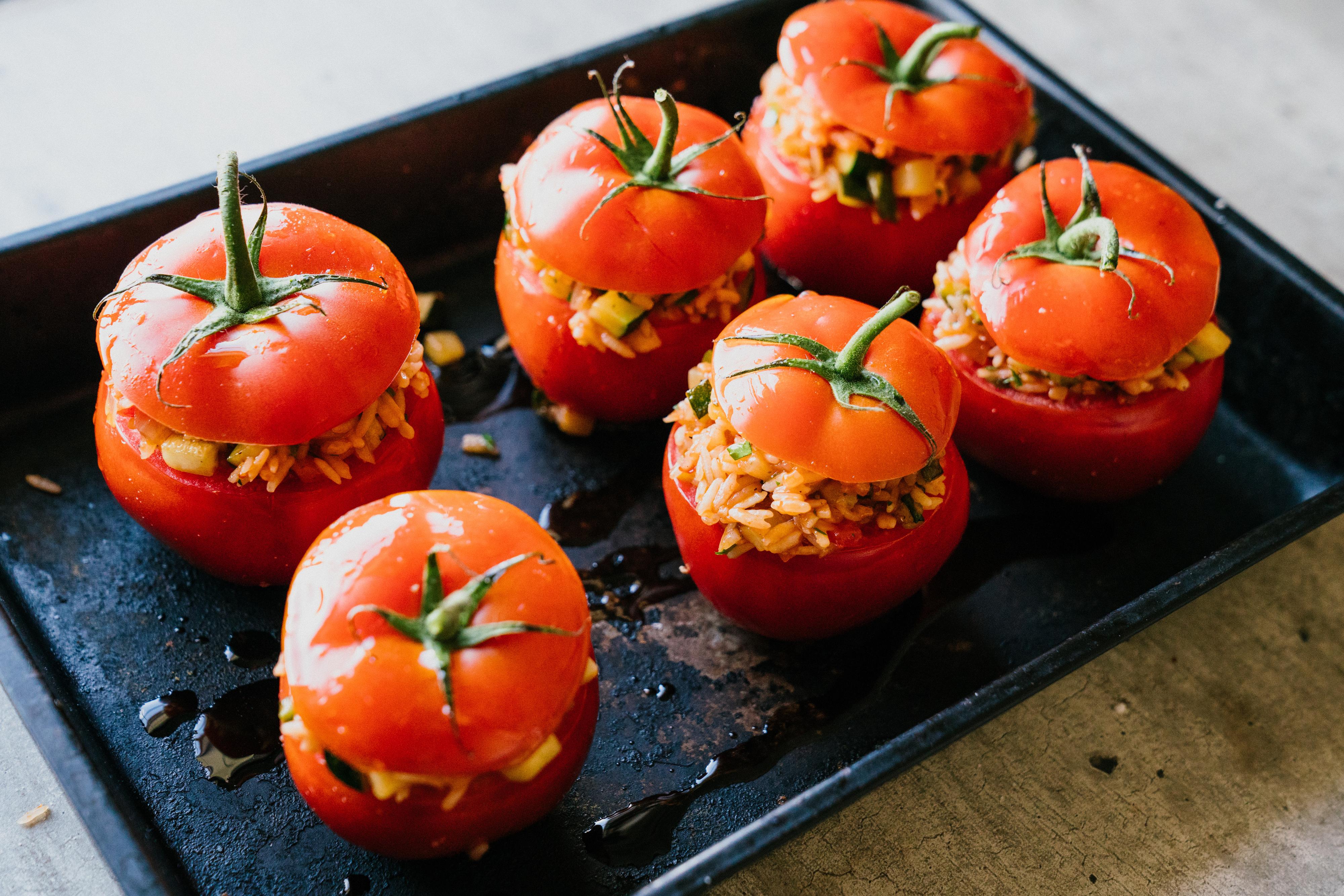 Varm ovnen til 180 grader. Sett tomatene over i en passende ildfast form og fyll dem godt opp med risblandingen. Drypp over litt olivenolje og sett på «tomatlokkene», avslutt med et par nye dråper olivenolje og bak tomatene midt i ovnen i cirka 40 minutter, eller til tomatene er gylne og flotte - og risen er mør.