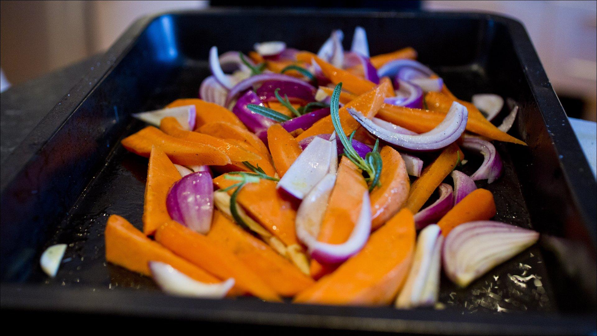 Rens og skjær gulrøttene i staver, søtpoteter i kløfter, løk i kløfter og hvitløk i skiver. Ha alt over i en ildfast form. Drypp over olivenolje, krydre med salt og kvernet pepper og vend alt godt sammen. Bak grønnsakene i ovn ved 200 grader i 15 – 20 minutter (eller til grønnsakene begynner å bli møre).