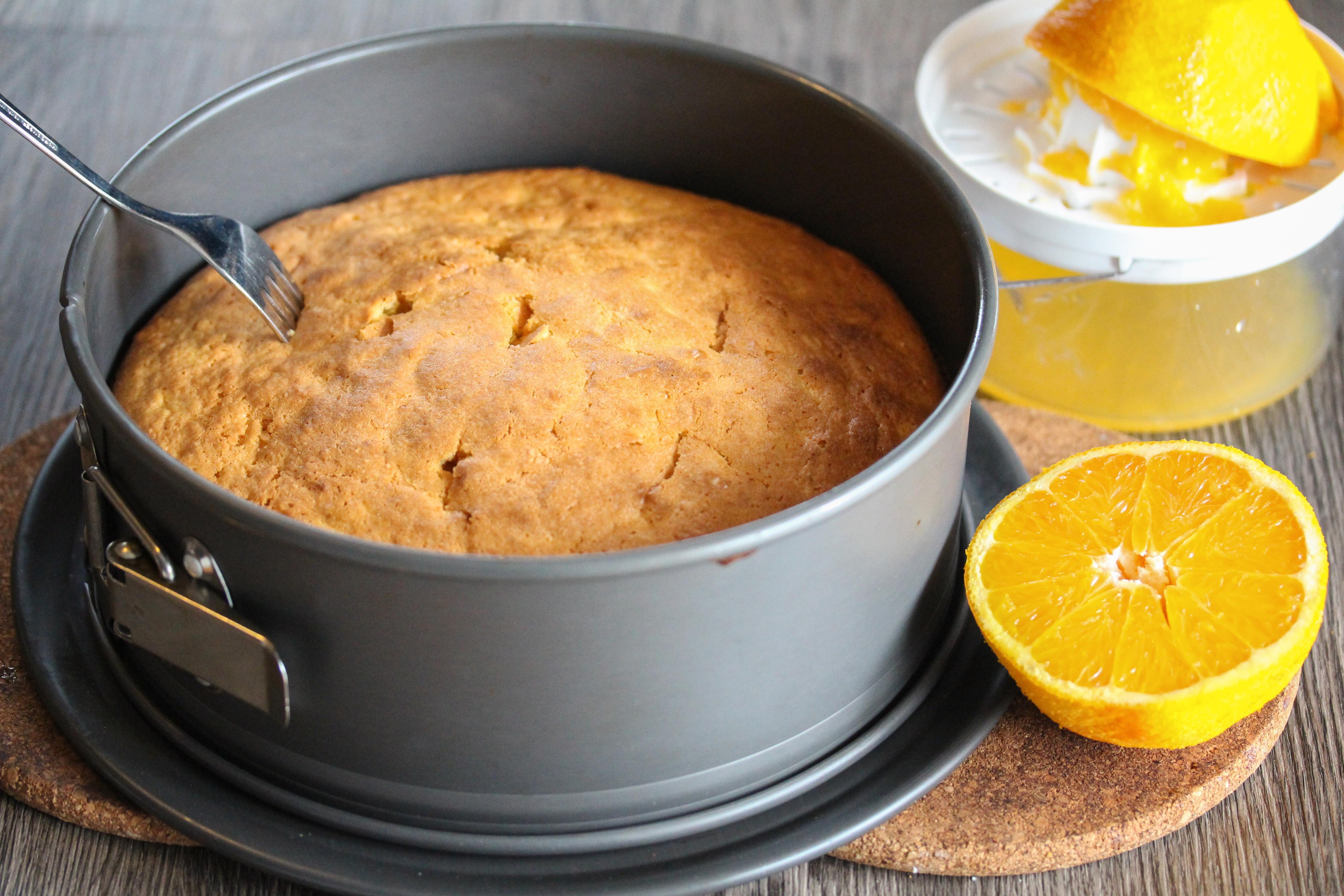 Stikk hull i den nystekte kaken med en gaffel. Press saften ut av appelsinen og hell dette over den varme kaken. La kaken stå og avkjøles i formen i 30 minutter, slik at saften trekker godt inn i kaken.